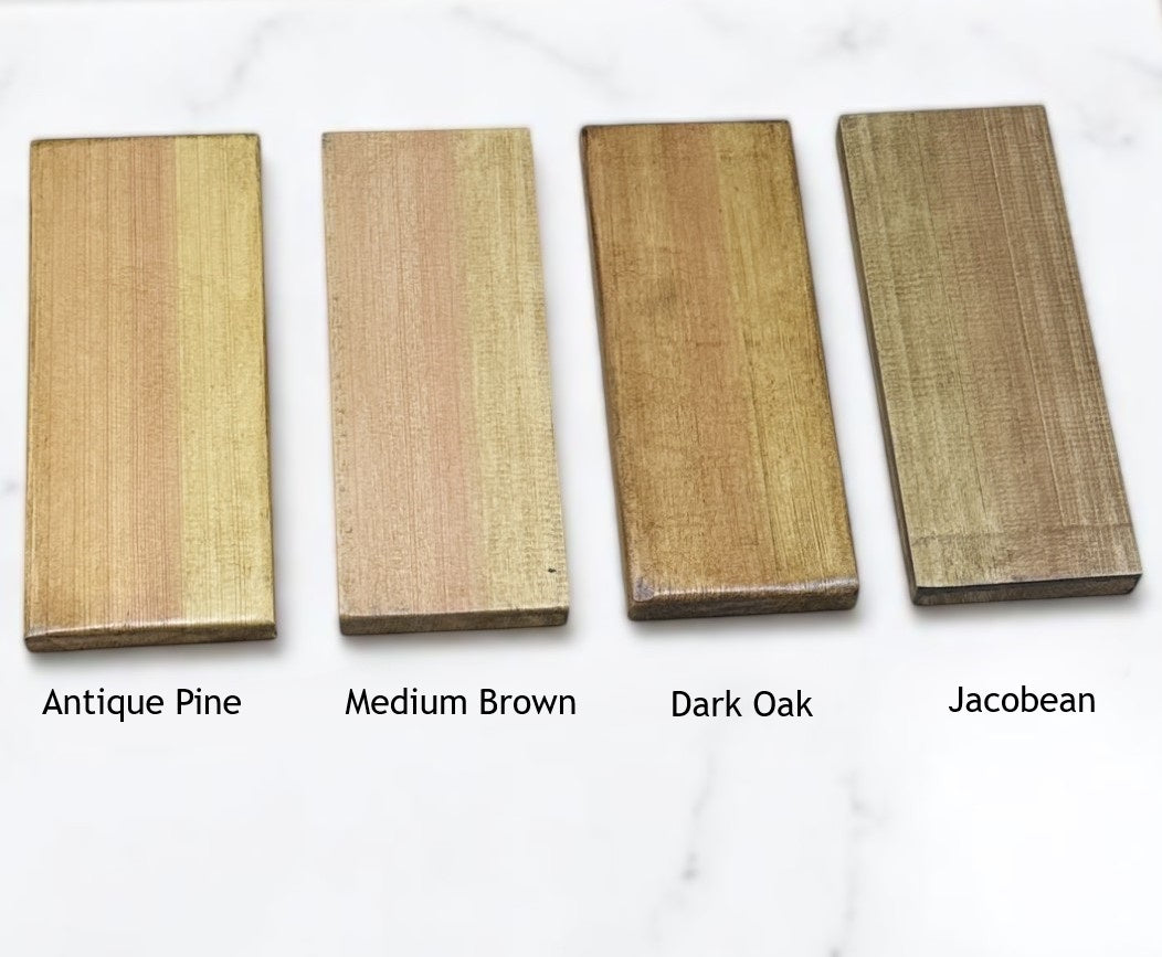 Four wooden planks in different finishes labeled 'Antique Pine', 'Medium Brown', 'Dark Oak', and 'Jacobean' on a white background.