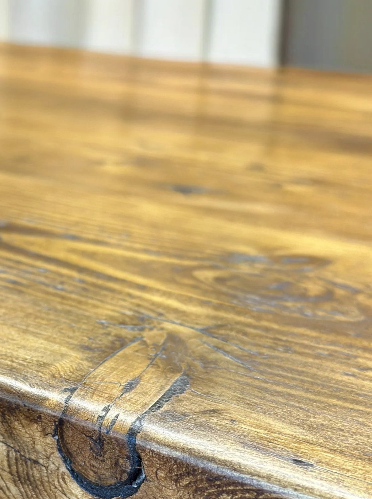 Close-up of a wooden surface with visible grain patterns.